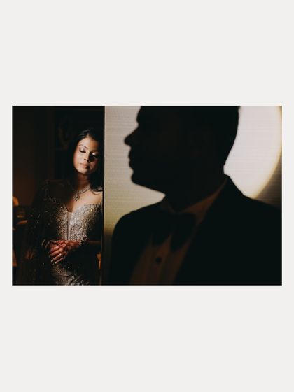 An artistic silhouette shot of Aabhaas and Radhika. This creative composition focuses on their forms and the space between them, creating a moody and intriguing portrait.