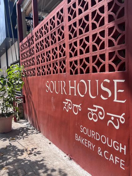 Another angle of the hand-painted typographic sign, showing how it integrates with the building's architecture.