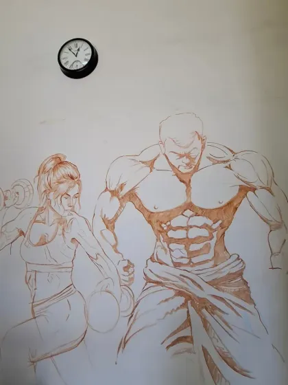 The initial outline sketch of the gym mural on the wall. This is the foundational step before we start adding layers of color.