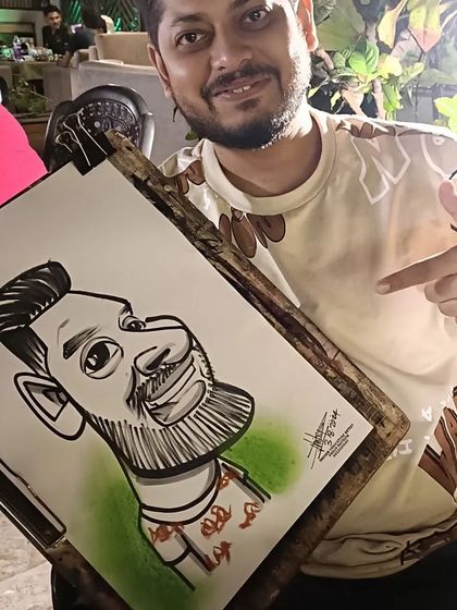 A guest pointing at his caricature with a smile.