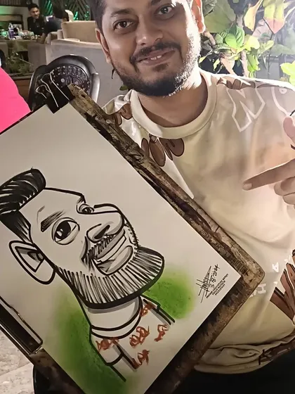 A guest pointing at his caricature with a smile.