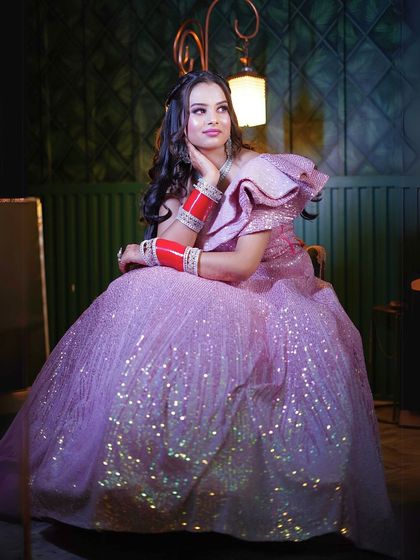 This sparkling pink gown with a ruffled shoulder is perfect for a fun and glamorous party look.