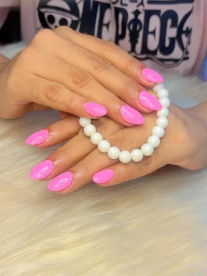A vibrant, Barbie-pink manicure. This fun and confident color is perfect for anyone who loves to stand out.
