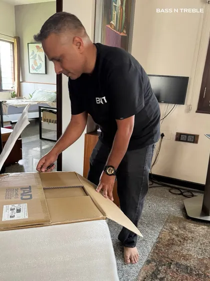 Denny carefully unboxes a new piece of high-end audio equipment for a client installation. The process begins with respect for the craftsmanship of the gear we work with.