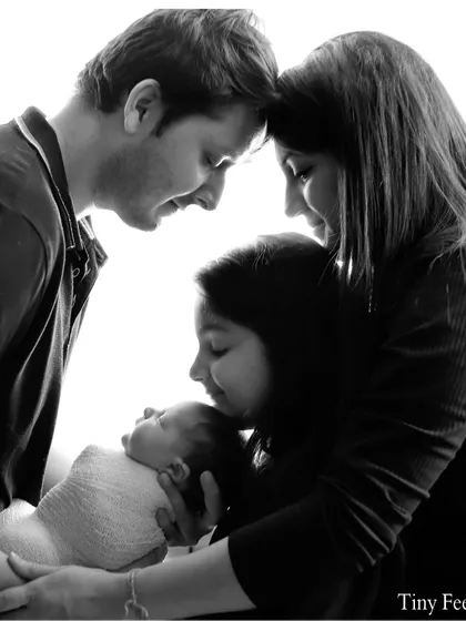 A timeless black and white portrait of the entire family welcoming their newest member. I focus on capturing the connection and love between parents, siblings, and the newborn.