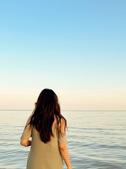A shot from behind, looking out at the calm water, creating a peaceful and serene image.