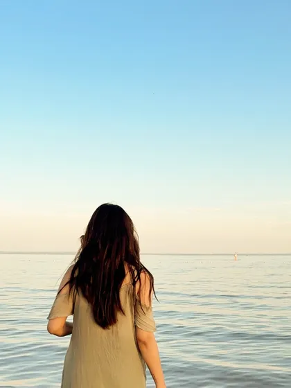 A shot from behind, looking out at the calm water, creating a peaceful and serene image.