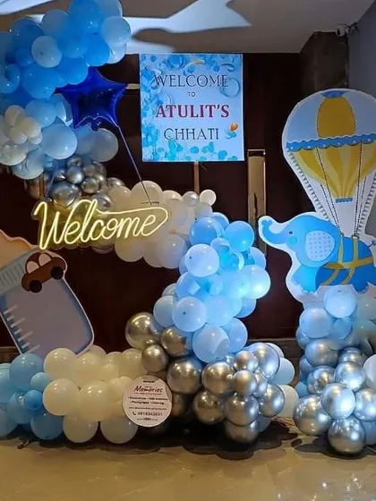 A festive decoration for a Chhathi ceremony. This setup includes a "Welcome" neon sign, a personalized poster, and creative balloon arrangements with elephant and hot air balloon cutouts.