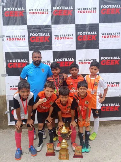 Another shot of our U11 team with their coach and runner-up trophy from the Independence Cup.