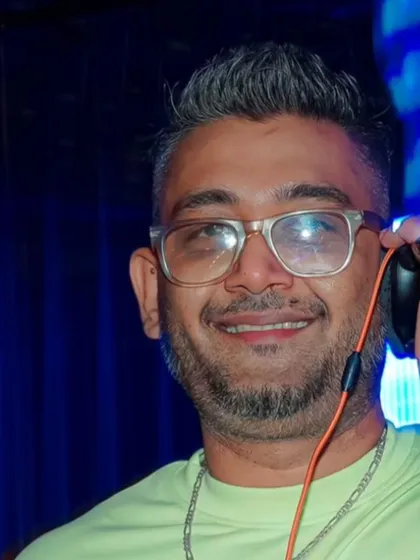 A candid shot of me smiling while cueing up the next track. This is the moment right before the beat drops.
