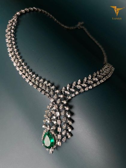 This diamond and emerald necklace shines just as bright as the festive lights. The cascading design is a beautiful reflection of tradition and elegance.