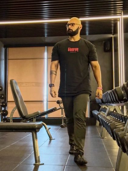 Walking through the dumbbell rack, in the zone. Routine and discipline are the cornerstones of a successful fitness journey.