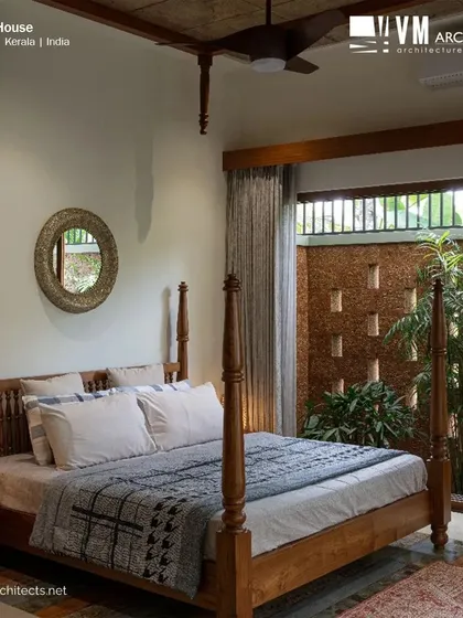 In this bedroom at Kuttiyil House, I designed a direct connection to a private courtyard. The four-poster bed adds a touch of classic elegance, while the large glass doors and the view of the laterite jali wall and greenery blur the line between indoors and outdoors, creating a peaceful personal retreat.