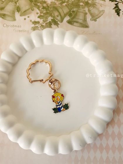 This Christmas candle charm keychain is a beautiful way to carry the light and warmth of the holiday season with you.