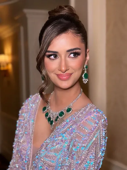 A smiling portrait that captures the joy and confidence this makeup look brings. The glossy lip and sparkling eyes are the perfect finishing touches.