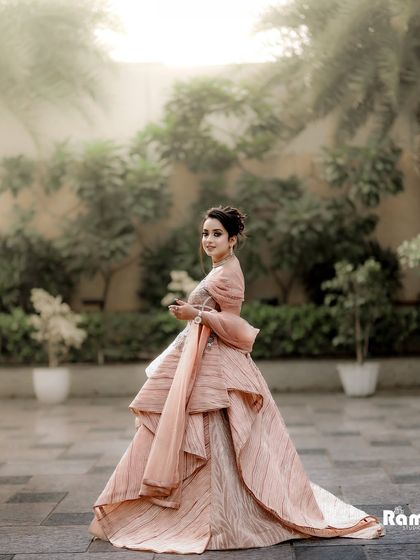 A beautiful portrait of the bride looking back with a gentle smile. The soft, hazy light and garden setting create a romantic and almost painted look for this stunning shot.