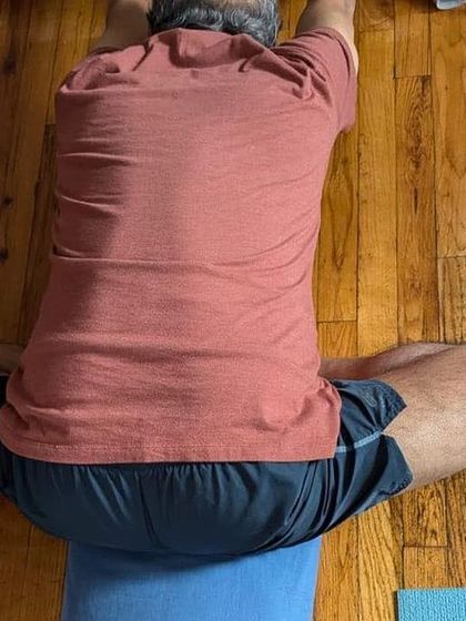A forward bend in Baddha Konasana (Bound Angle Pose).