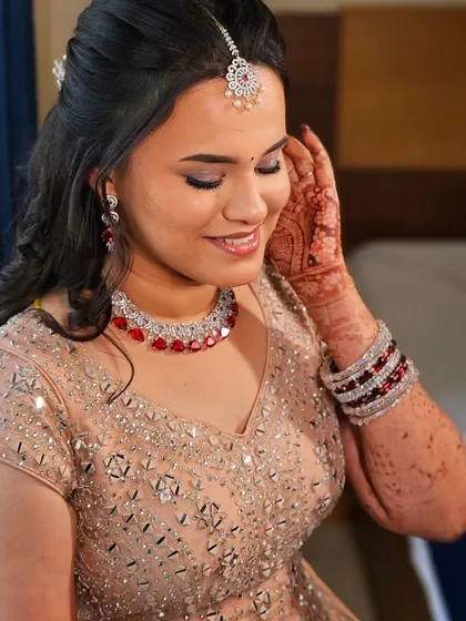 A close-up of a bride's reception look. The soft makeup and beautiful jewelry make her look absolutely stunning.