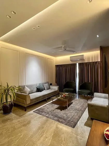 This living room uses layered lighting to create a warm and inviting mood. We combined cove lighting in the ceiling with vertical light strips along the walls to highlight the textured paint and elegant paneling.