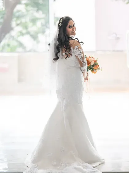 A lovely bridal portrait with a bright, happy feel. The bride's glance over her shoulder and her smile create a charming and candid-style photo.