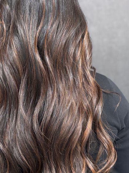 A close-up view of the delicate caramel highlights woven through a dark base, creating a beautiful, multi-tonal effect.