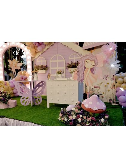 A wide shot of the purple fairy house setup, showing how all the elements, including the butterfly table and character cutouts, come together to create a complete magical world.