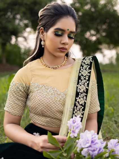 This image shows how the creative makeup look is integrated into a full concept for a photoshoot, from the outfit to the natural, outdoor setting.