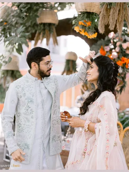 A playful, candid moment between the couple during their Haldi ceremony, their easy chemistry shining through.