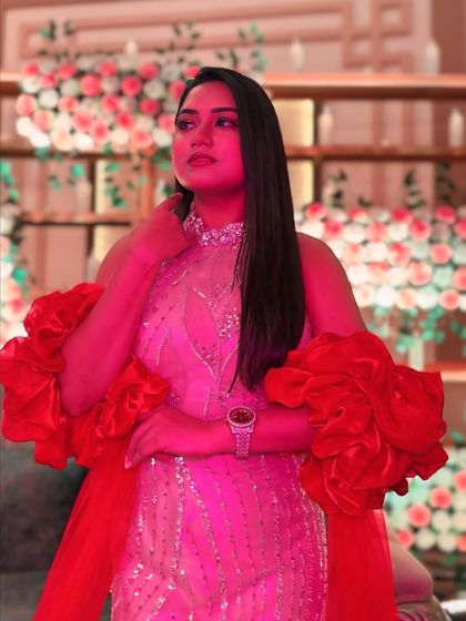 Another angle of the beige and red gown, highlighting the intricate details on the bodice and the flow of the red sleeves.