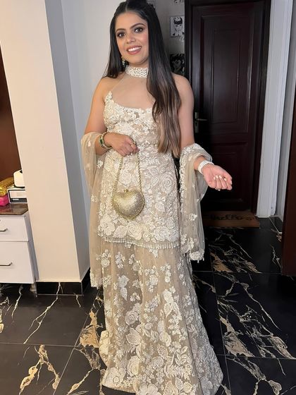 A full shot of a client in a beautiful Seema Gujral outfit, her soft glam makeup looking simple and elegant.