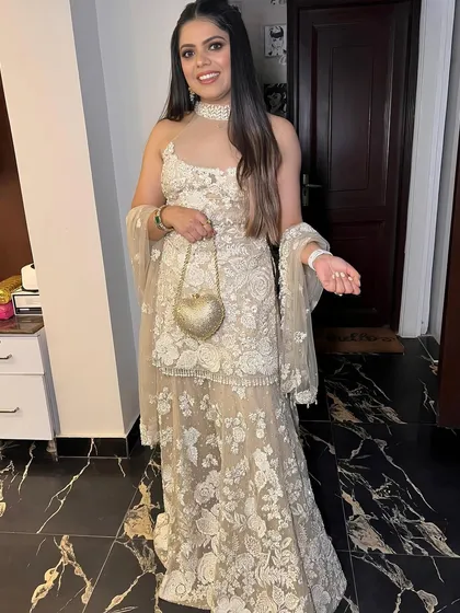 A full shot of a client in a beautiful Seema Gujral outfit, her soft glam makeup looking simple and elegant.