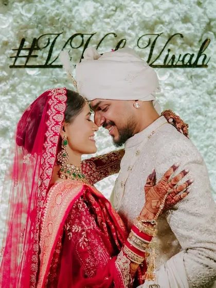 A sweet, intimate moment against their wedding hashtag. This photo is all about their connection, shutting out the world for a second to just be with each other.