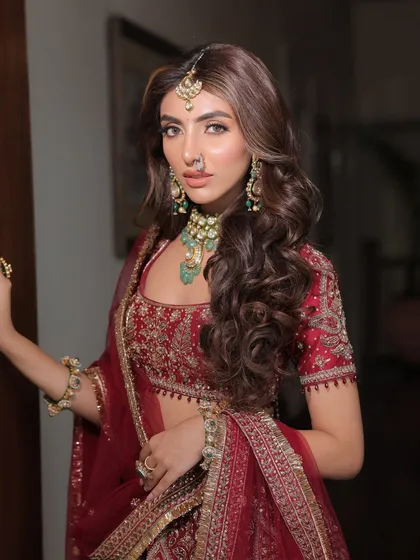 A confident pose that showcases the full bridal look. The styling here is about creating a strong, memorable image of the bride on her special day.