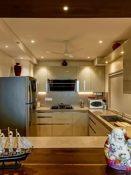 A view of the C-shaped acrylic kitchen from the breakfast bar, showing its open and inviting design.