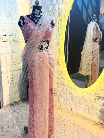 The 'CHAMKEELI' saree against our studio's feature wall. The way it catches the light is simply magical, perfect for an evening event.