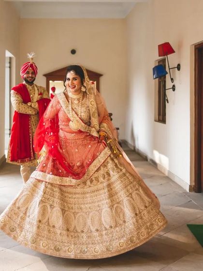 A joyful twirl from the bride as her groom looks on. This captures the beautiful movement of her lehenga and her happiness.