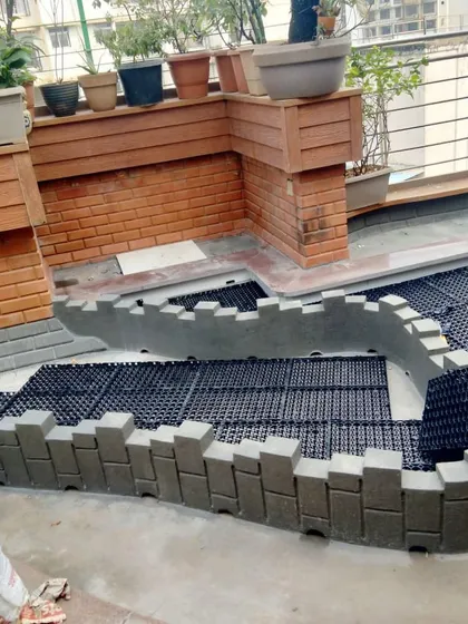 A curved planter wall being built on the drainage foundation. This shows how we can create organic shapes and custom features as part of a terrace garden design.