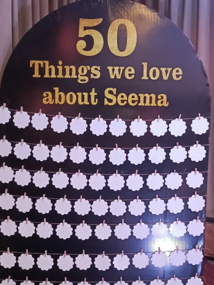 A creative and interactive element for a 50th birthday: a board for guests to write "50 things we love about Seema". It's a wonderful personal touch.