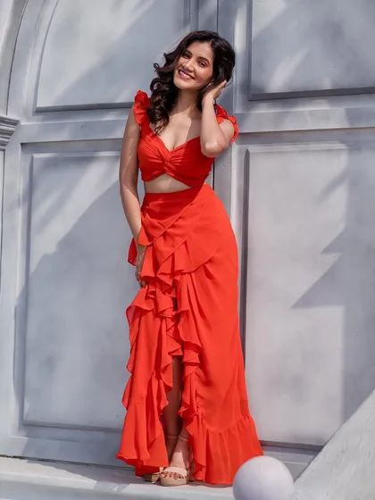 A happy and radiant shot of the model in the red co-ord set, perfect for a fun and romantic pre-wedding shoot.