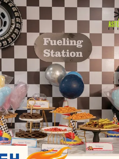 The "Fueling Station" at a racecar-themed party. We designed a fun and thematic snack table with treats cleverly named "Spare Tires" and "Jumper Cables" to delight the kids.