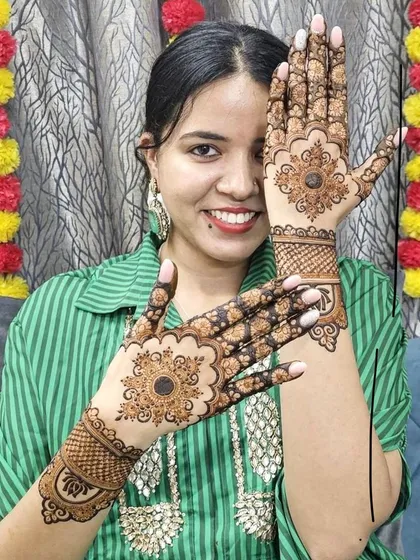 A happy client showing off her Karwa Chauth mehndi. The design features classic mandala patterns, perfect for festive occasions when you want something traditional and beautiful.
