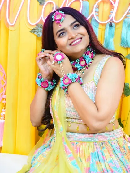 A beautiful bride-to-be showing off her intricate floral jewelry during her Mehendi ceremony. I focus on capturing the vibrant colors, details, and happy smiles of pre-wedding functions.