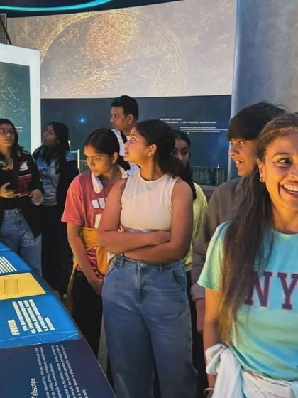 The team engaged and learning at the astronomy exhibit. We believe in nurturing well-rounded individuals, not just athletes.