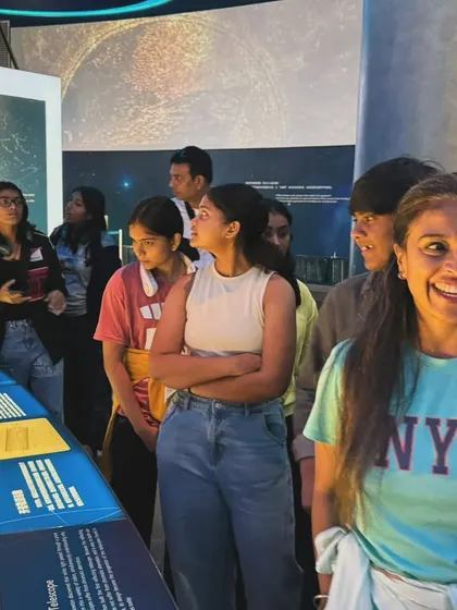 The team engaged and learning at the astronomy exhibit. We believe in nurturing well-rounded individuals, not just athletes.