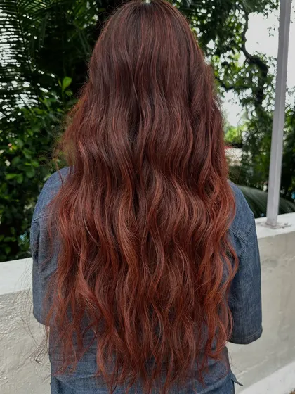 Holiday hair with a twist. This gorgeous reddish-copper color is perfect for making a statement on your next vacay. It’s warm, vibrant, and full of life.