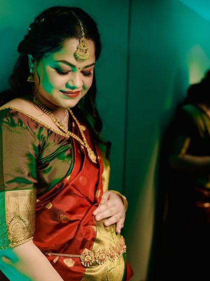 A beautiful, artistic portrait of a glowing mommy-to-be, capturing a quiet moment of reflection during her baby shower celebration.