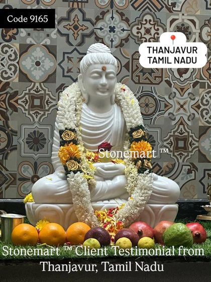 A close-up of the 2-foot marble Buddha statue from our client in Thanjavur, decorated with a beautiful flower garland and offerings.