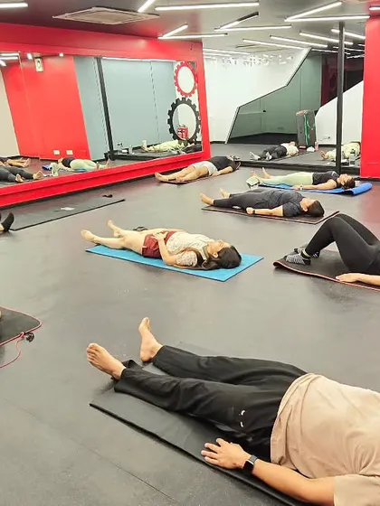 Students in Savasana (Corpse Pose), a state of conscious relaxation. This pose is crucial for integrating the benefits of the practice, calming the mind, and restoring the body.