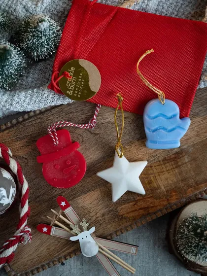 A closer look at my handmade Christmas wax ornaments. This set includes a snowman, a star, and a mitten, all ready to hang with festive twine.