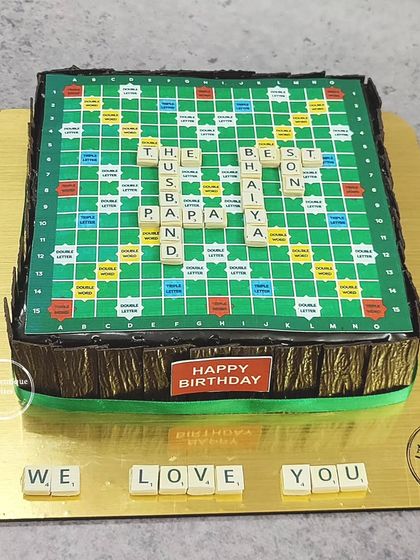 A Scrabble board cake for the best husband and papa. The edible tiles spell out a sweet message, making it a personal and fun design.